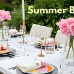 Summer brunch table setting with pink roses, white plates, and glass vases on white tablecloth