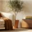 Warm small apartment living room with a wooden storage console, olive tree, and terracotta accents creating an organized yet cozy space