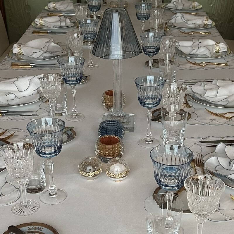 Luxury Baccarat crystal glassware display with blue goblets and crystal lamp showing the difference between crystal and everyday glass