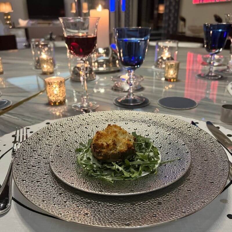 Blue colored water goblet and wine glass on luxury dinner table place setting showing how colored glassware adds personality to a table
