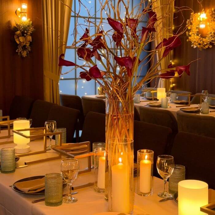 Tall flower arrangement for dining table with calla lilies and curly willow branches