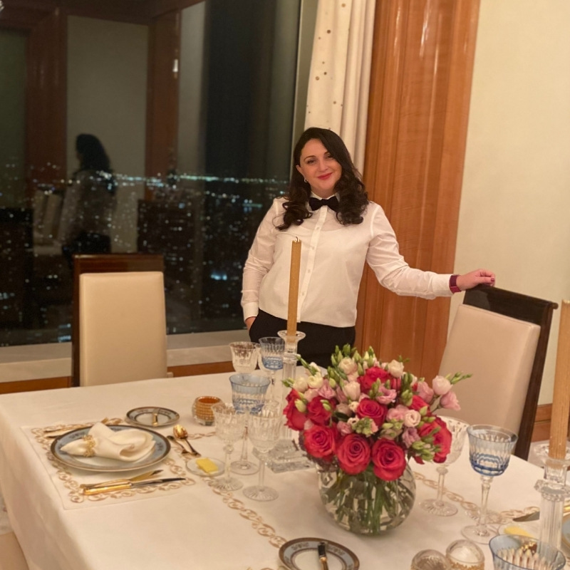 Professional table stylist preparing a dinner party table in a New York setting