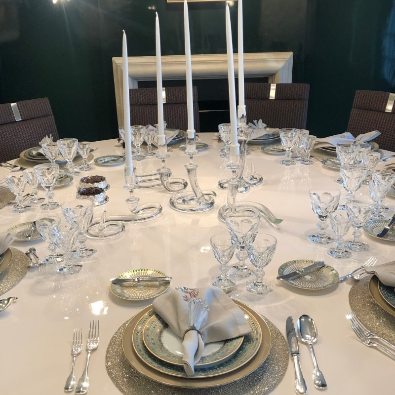 basic place setting with dinner plate fork knife spoon and napkin ring