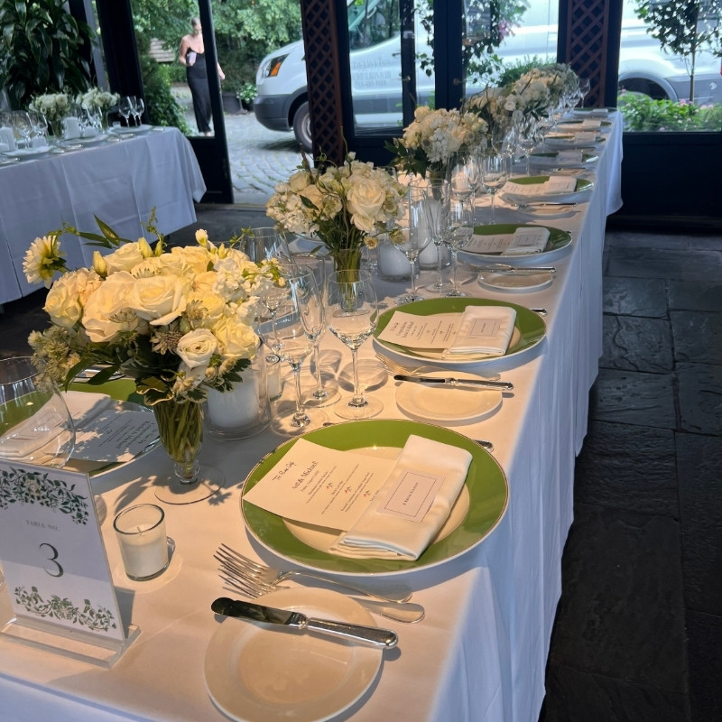 dinner party table setting with white flowers and crystal glassware