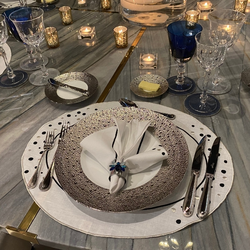 elegant table setting with tall taper candles and crystal glassware