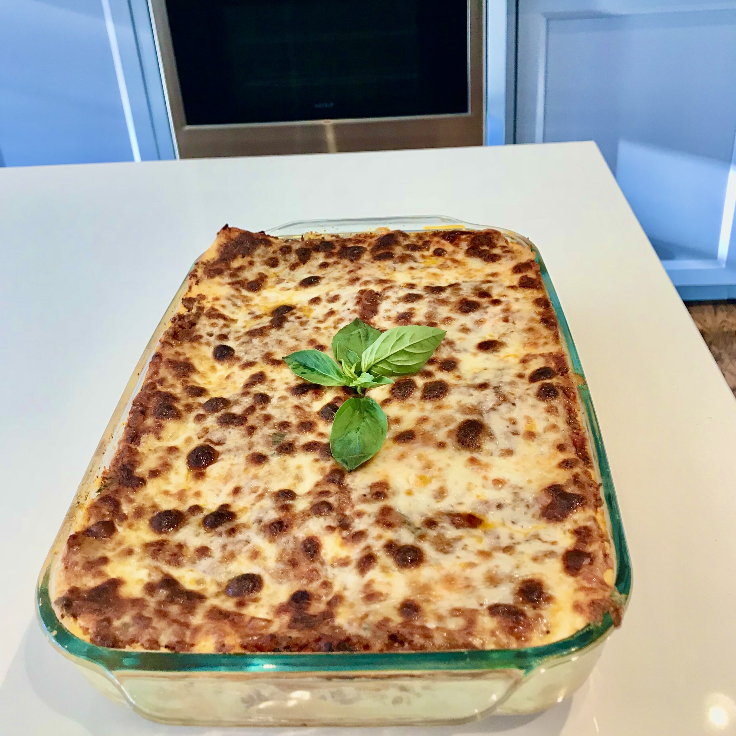 Homemade lasagna fresh from the oven, an easy make-ahead dinner party main dish