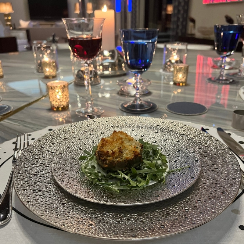 Scented candle for dinner party ambiance placed away from the dining table