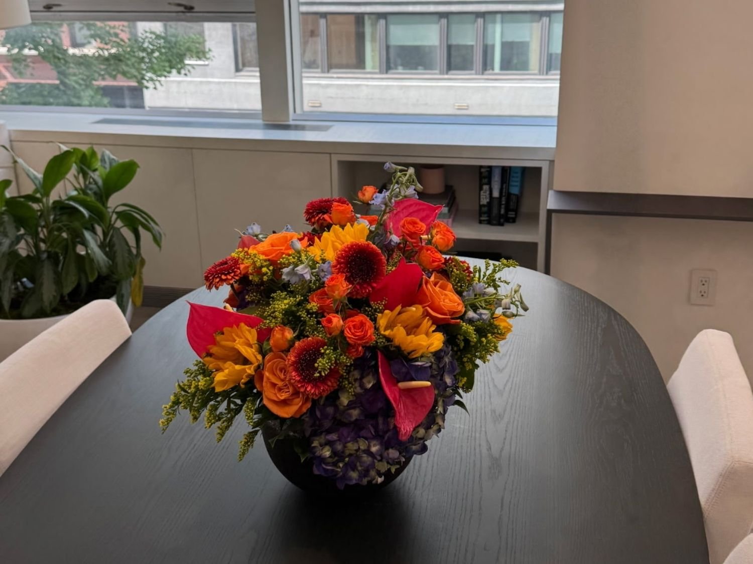 Same stone vase with sunflowers and anthurium for an autumn kitchen table centerpiece